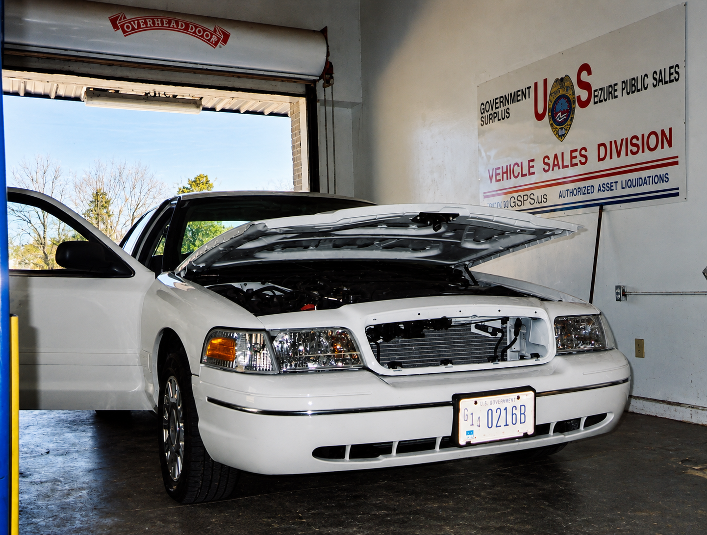 A government fleet Crown Victoria undergoing service with the hood open and front equipment removed circa 2002.