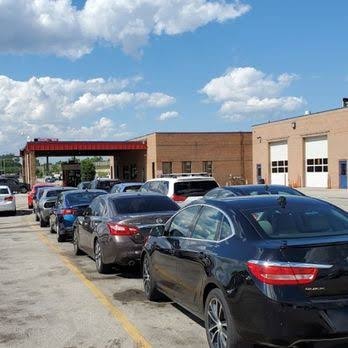 Vehicles lined up at an automobile auction facility
