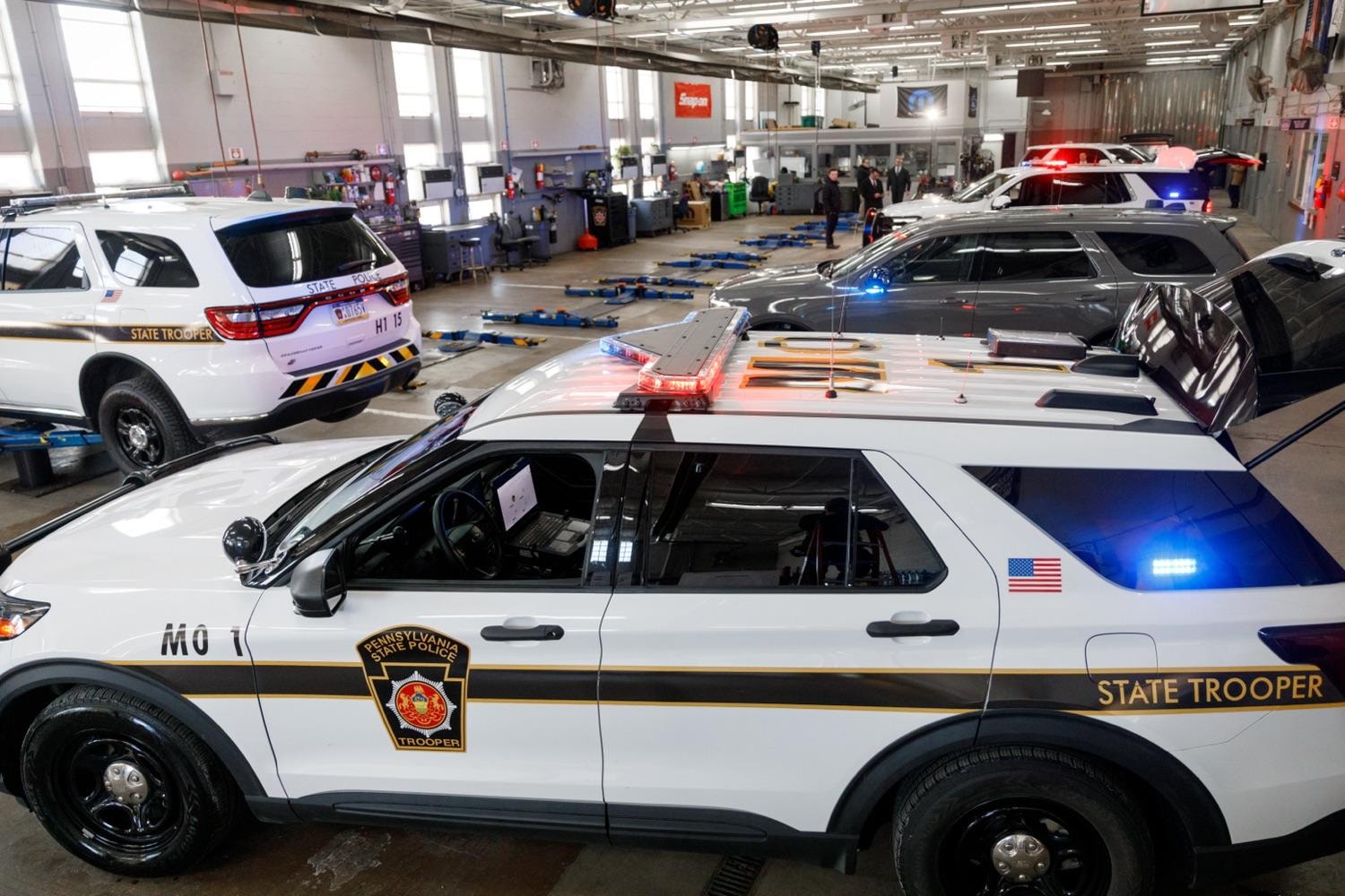 Pennsylvania State Police vehicles inside a modern fleet facility