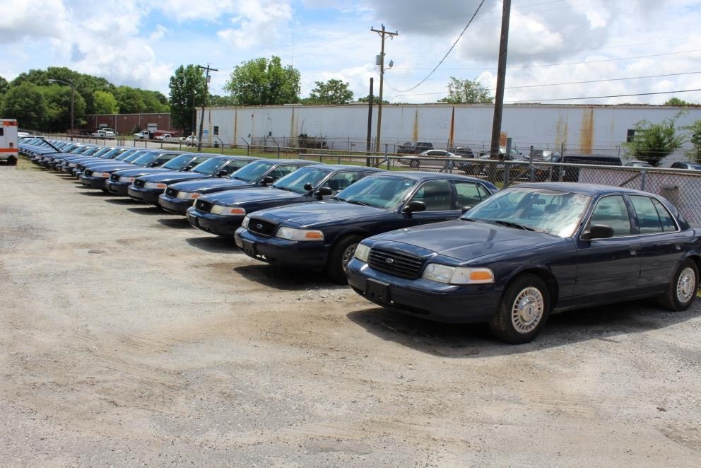 Rows of retired government fleet sedans at South Carolina State Surplus in West Columbia
