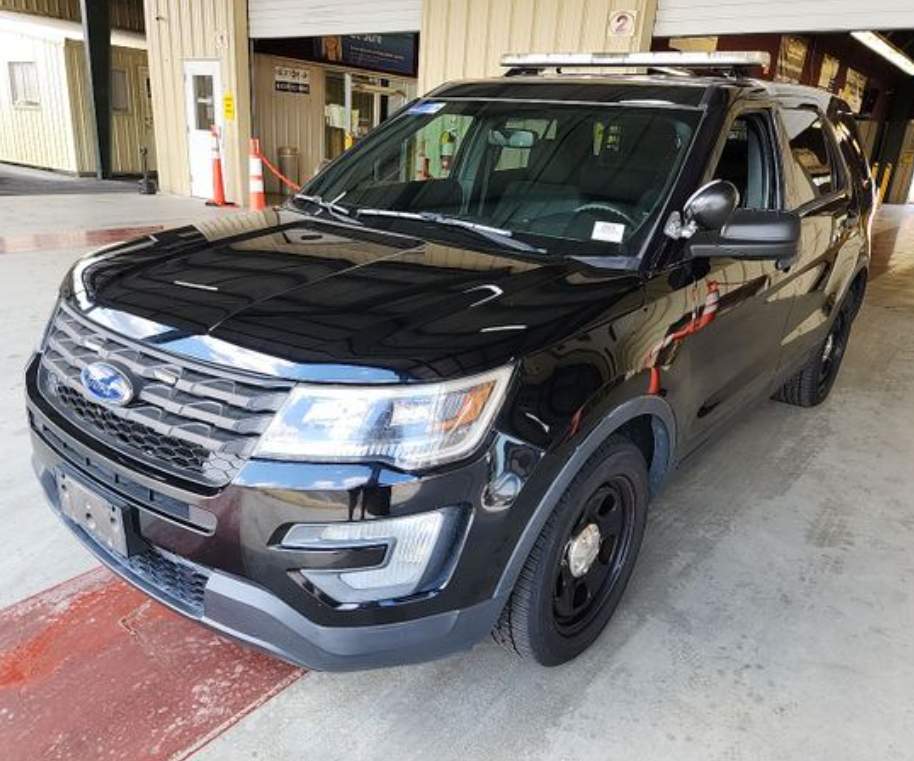 A former government Ford Explorer inside the commercial auction facility.