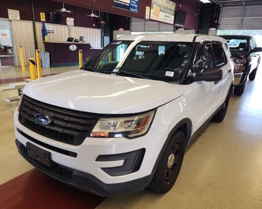 A decommissioned government Ford Explorer positioned inside the auction facility before sale.