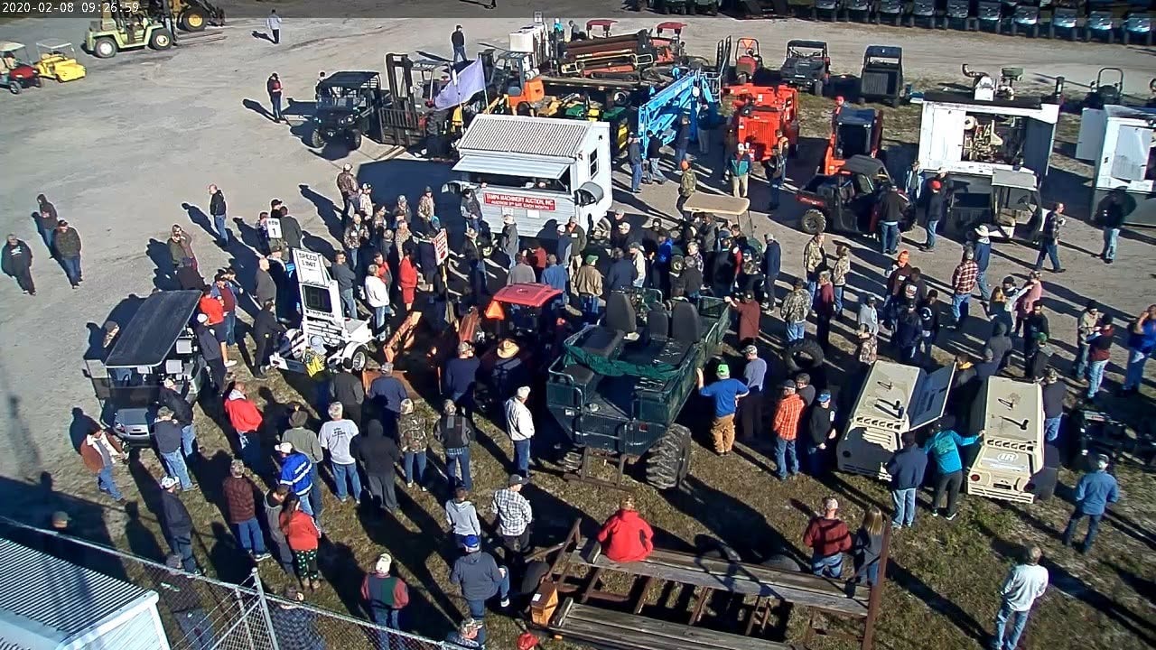 Crowd gathered around equipment during a live Tampa Machinery Works auction