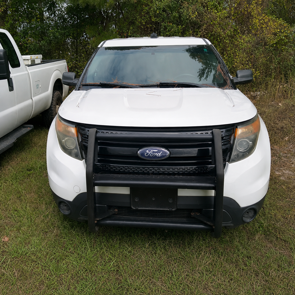 White 2014 Ford Explorer Police Interceptor with a black push bumper, seen from the front