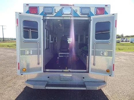 The Ford grille, the driver's cab and the rear doors opening onto the patient compartment.