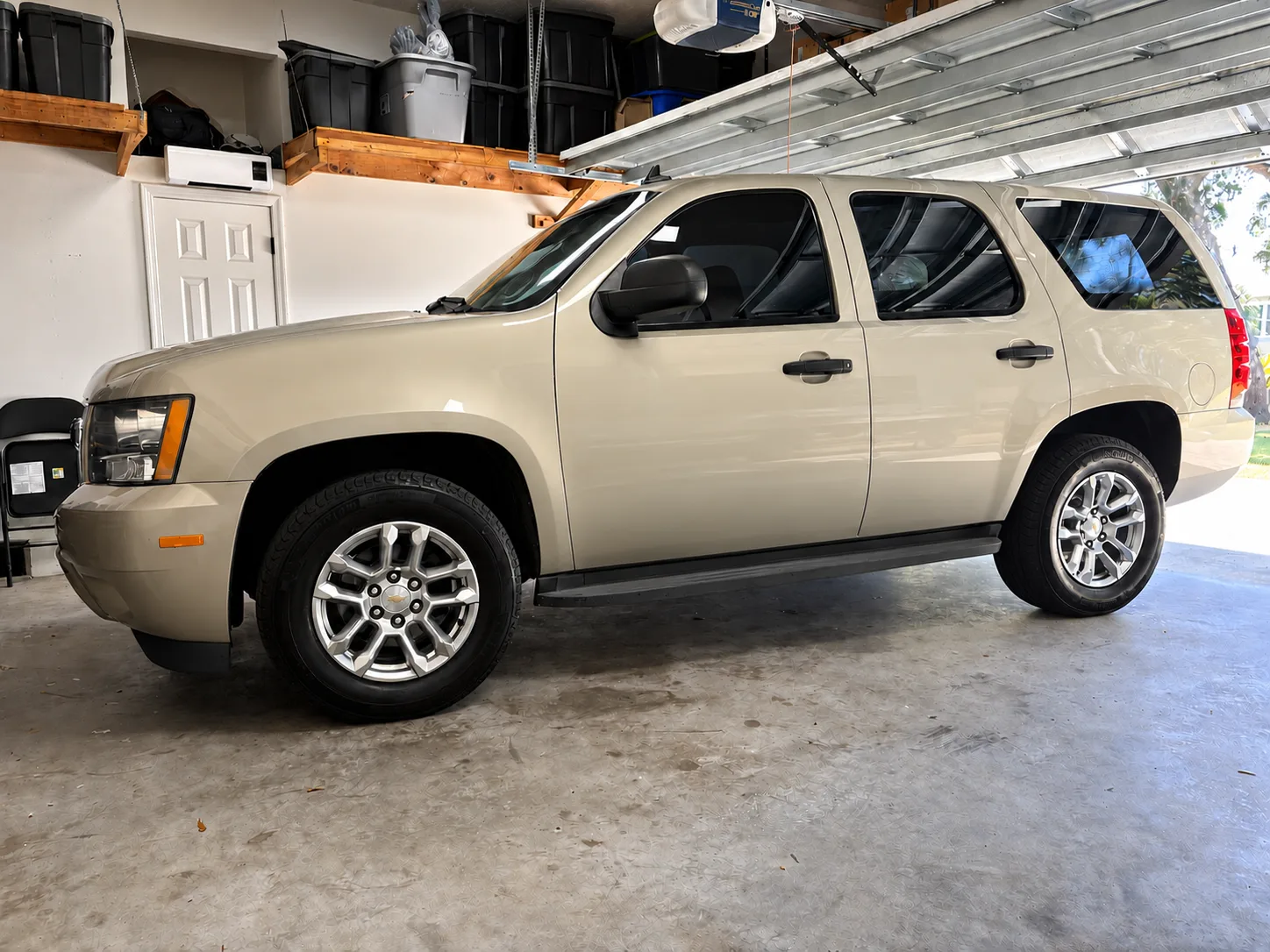 The finished 2014 Chevrolet Tahoe parked in Terry O’Connor’s garage, side view showing the new paint, wheels and tires