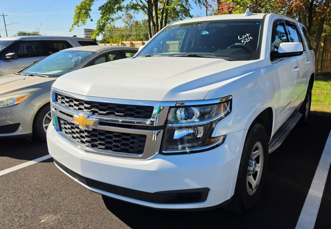 A white Chevrolet Tahoe of the 2015 to 2020 body style in the Delaware Surplus Services yard.