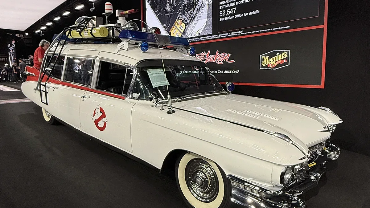 A white Ghostbusters Ectomobile re-creation on display under the lights at a Barrett-Jackson auction