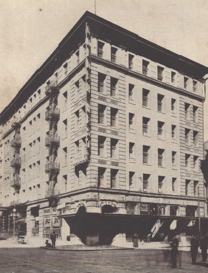 A black and white photo of the six-story Golden West Hotel on a San Francisco street corner