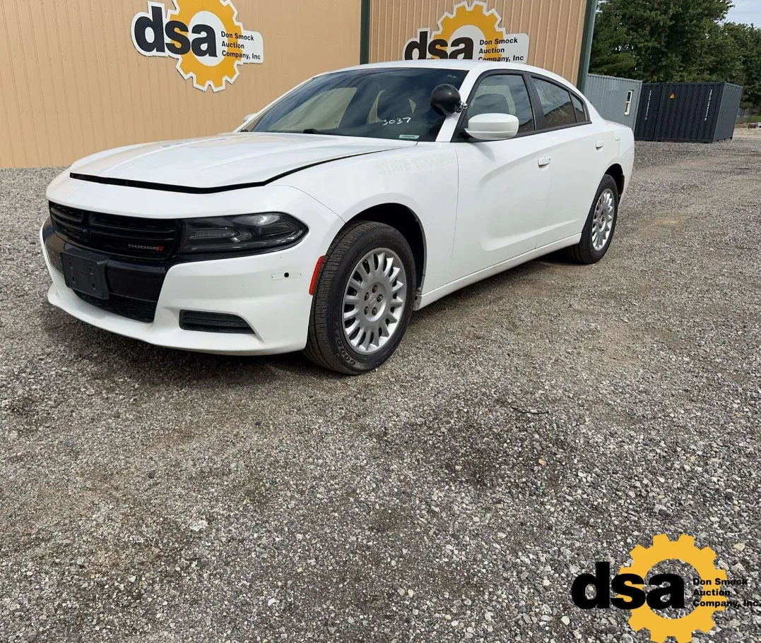 A white Dodge Charger Pursuit with the State Trooper ghost lettering still faintly visible on the door.