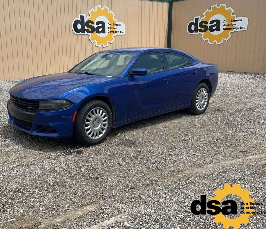 A dark blue Dodge Charger Pursuit, front three-quarter view, on the gravel at the Pendleton yard.