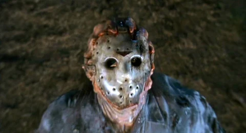 Jason wearing the burnt, battered hockey mask from Jason Goes to Hell, fused to his face