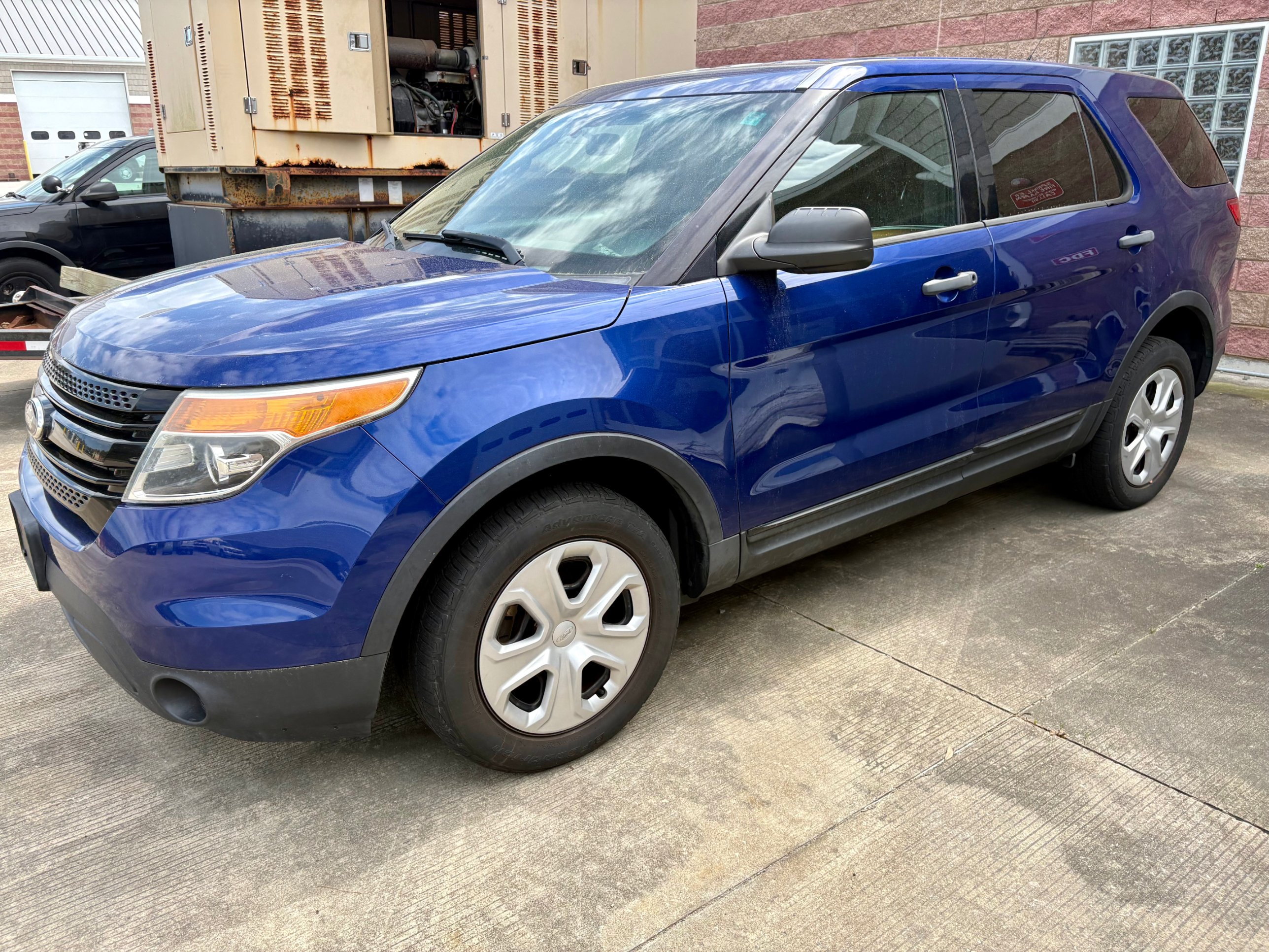 Blue 2015 Ford Explorer Police Interceptor Utility seen from the front passenger side
