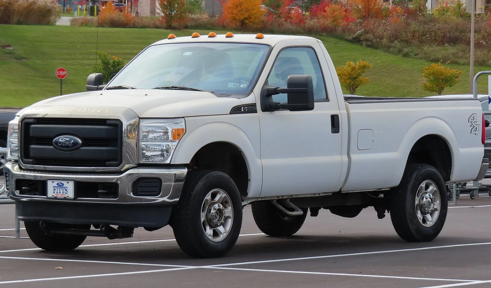 A white 2016 Ford F-250 Super Duty XL regular cab pickup, front left view, in a parking lot.
