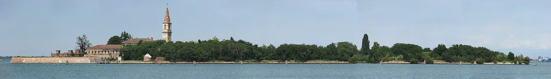 A wide panorama of Poveglia's tree-covered shoreline and bell tower