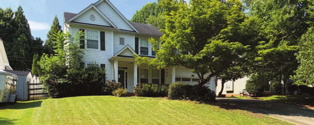 A two-story white colonial with black shutters on a green lawn, 2721 Briar Ridge Drive, Charlotte.