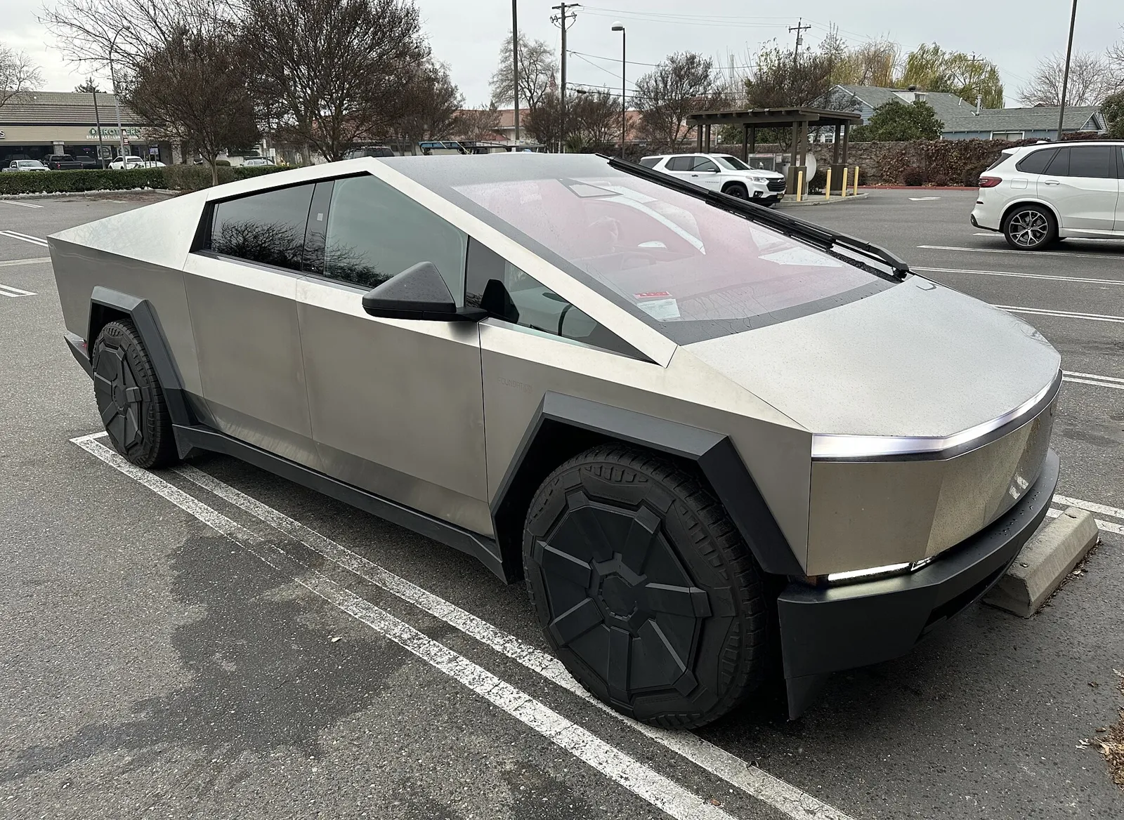 A stainless-steel Tesla Cybertruck parked in a hardware store lot in Ripon, California.