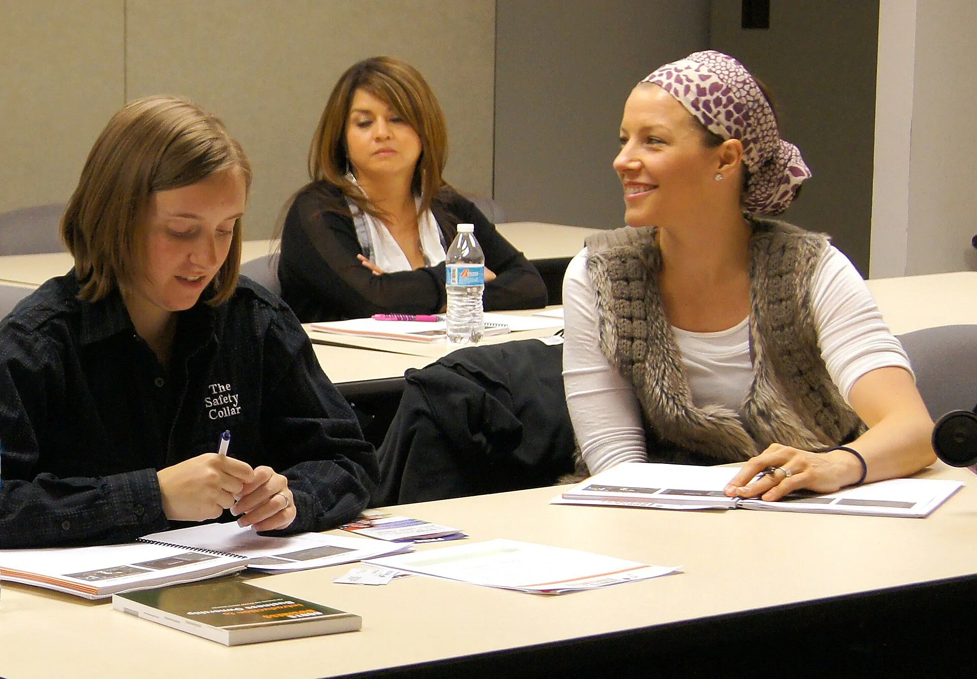 Military veterans and family members taking notes at a Boots to Business workshop at the Arizona National Guard Soldier Support Center.