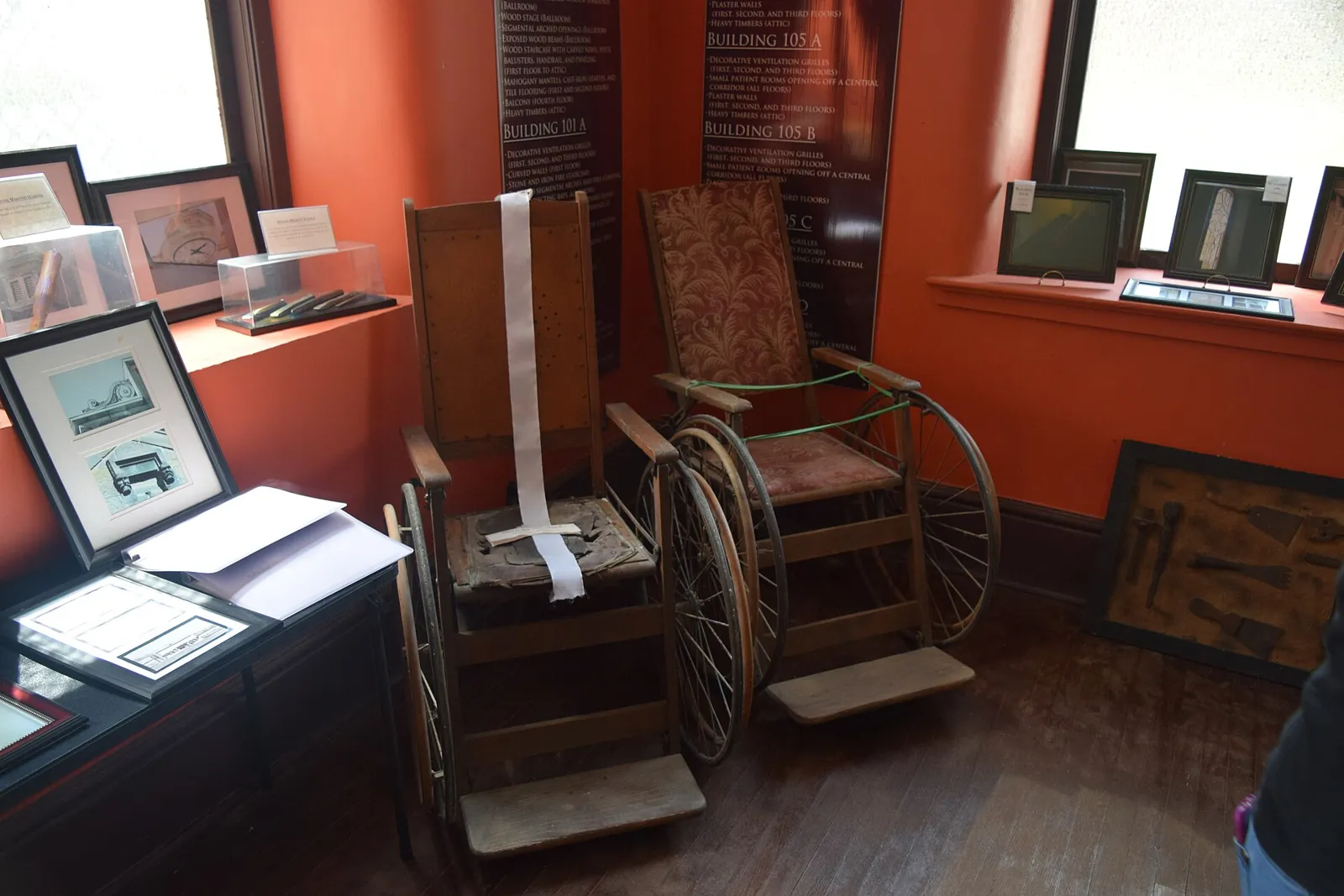 Antique wheelchairs, a violin, a harmonica, a convex mirror and other pieces from the asylum's collection.
