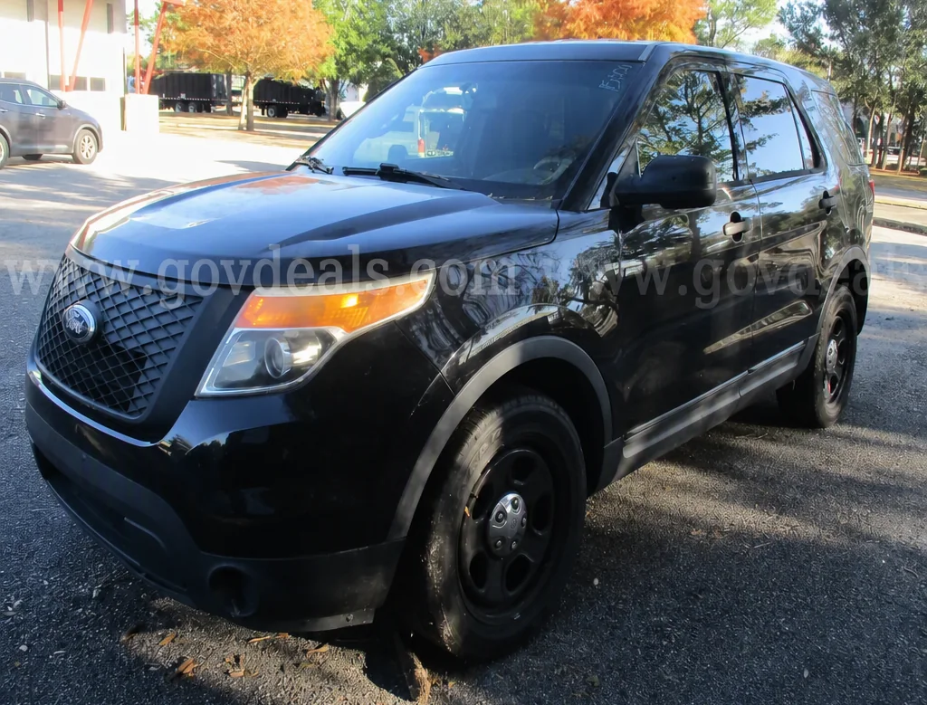 The black 2015 Ford Police Interceptor Utility, Unit 01, in the GovDeals listing photo.