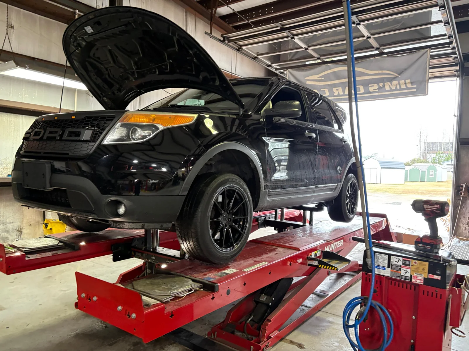 The 2015 Ford Police Interceptor Utility on an alignment rack in the shop.