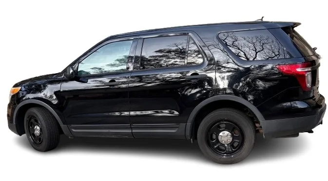Side view of the black 2015 Ford Police Interceptor Utility with no spotlight and no roof equipment.